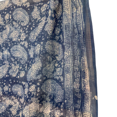 A dupatta/sarong with Anokhi block print in navy color, featuring floral and geometric patterns, draped over a white background.