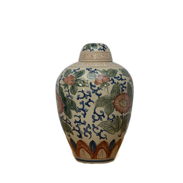 Decorative ceramic jar with floral patterns on a white background