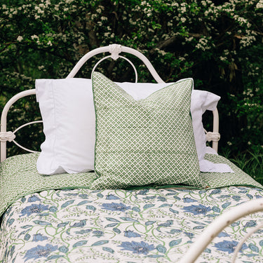 A cotton quilt with green and blue block printed design