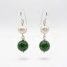 A pair of dangle earrings. Each earring has a white pearl, a green jade bead, and silver hooks.