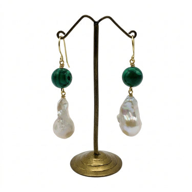 A pair of drop earrings.  Each earring has a round dark green malachite bead, a gold fishhook ear wire, and a large, irregular white baroque pearl dangle.