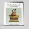 A spiral-bound 2027 desk calendar shown upright on a light gray background. The front cover features the text 'Michaela Laurie Australian Enchantment' above an illustration of a tan hat resting on stacked books, with a small blue-and-white bird perched on top.