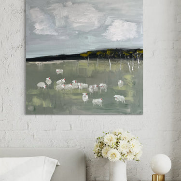 A square canvas painting of a pastoral landscape with white sheep grazing in a green field under a cloudy grey sky,