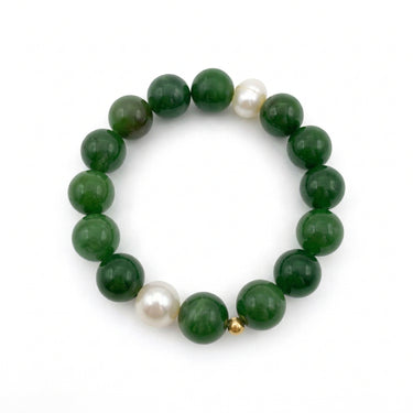 A beaded stretch bracelet featuring glossy dark green jade round beads, accented by two white freshwater pearls and a small gold spacer bead