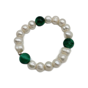 A stretch bracelet featuring lustrous white baroque pearls and three round dark green malachite beads

