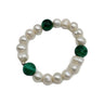 A stretch bracelet featuring lustrous white baroque pearls and three round dark green malachite beads
