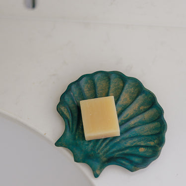 A green brass scallop soap dish