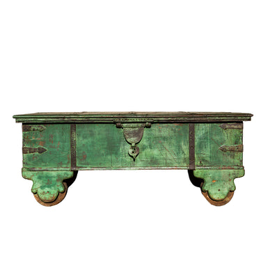 Vintage green wooden trunk with metal handles on a white background