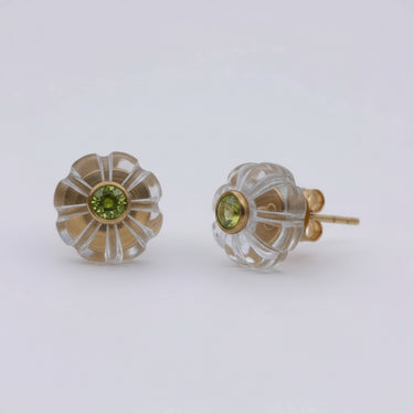 Pair of gold and clear glass earrings on a white background