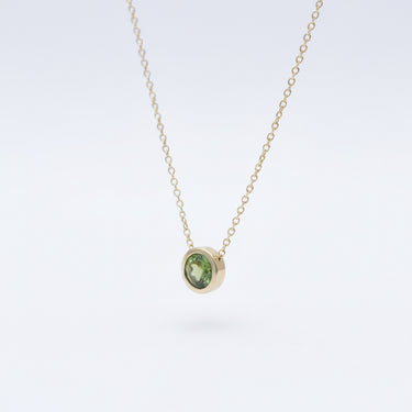 gold Necklace with a peridot gemstone pendant 