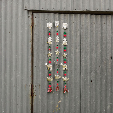 hanging pressed metal Christmas symbols with pompoms