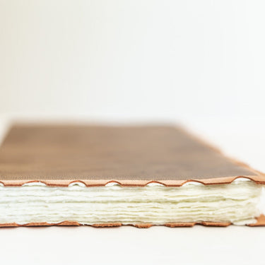 leather-bound journal with hand-torn cotton pages