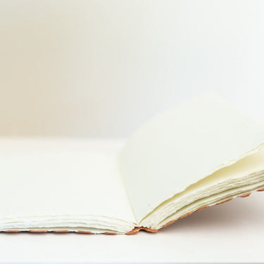 leather-bound journal with hand-torn cotton pages
