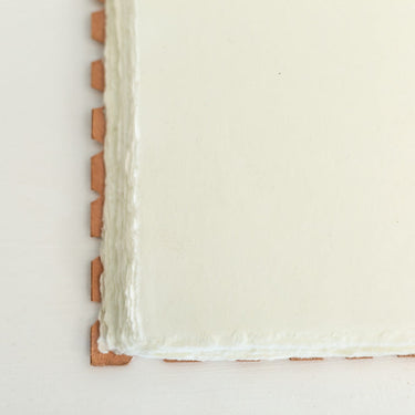 leather-bound journal with hand-torn cotton pages