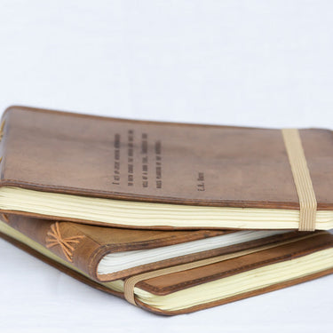 leather-bound notepads with quotes and hand-stitched spines